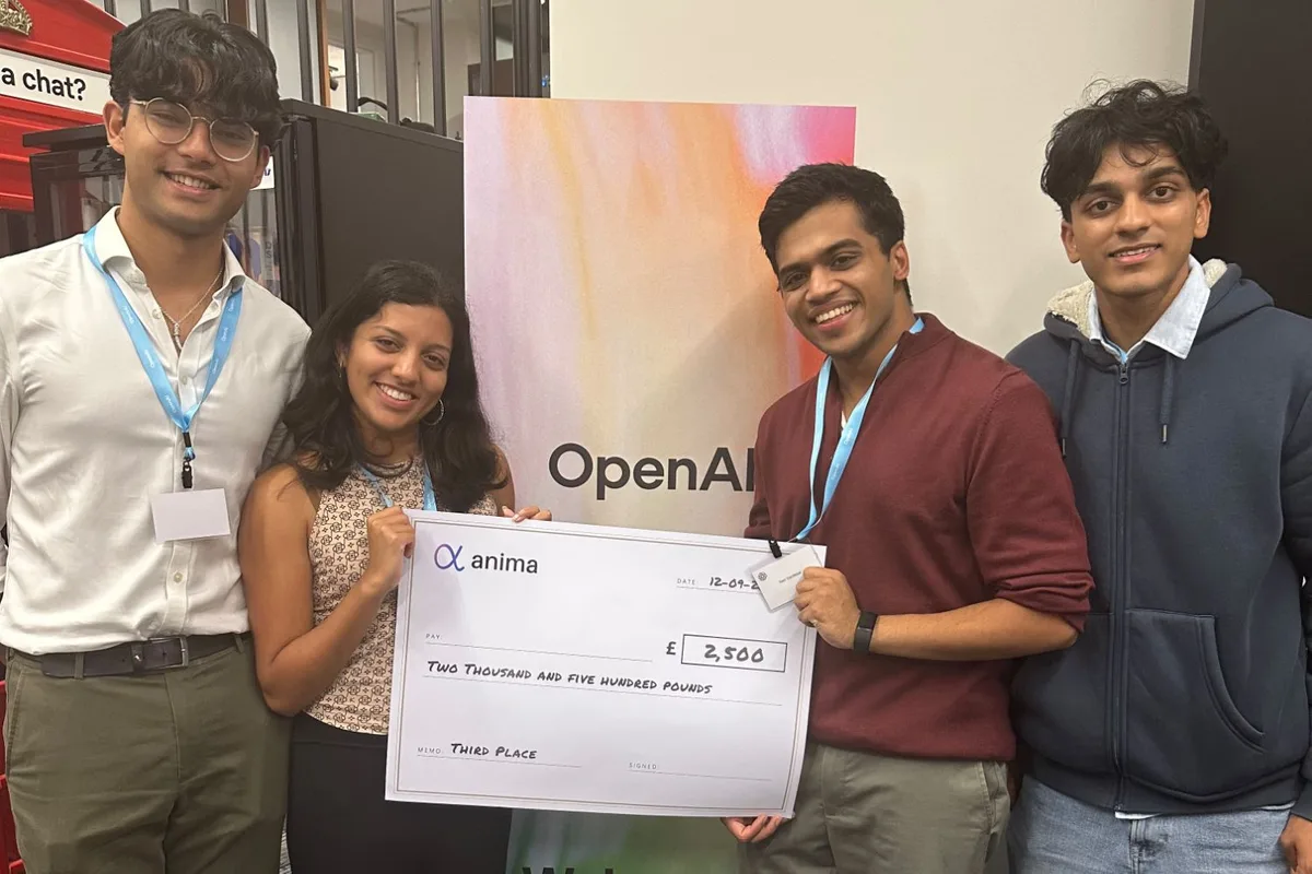 Four members of the NHS-Onboard team holding an oversized Anima cheque for £2,500 marked Third Place, in front of an OpenAI welcome banner
